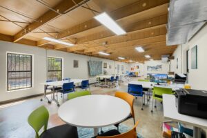 Photo of the main room at Key Coworking, mostly tables and chairs; flex space